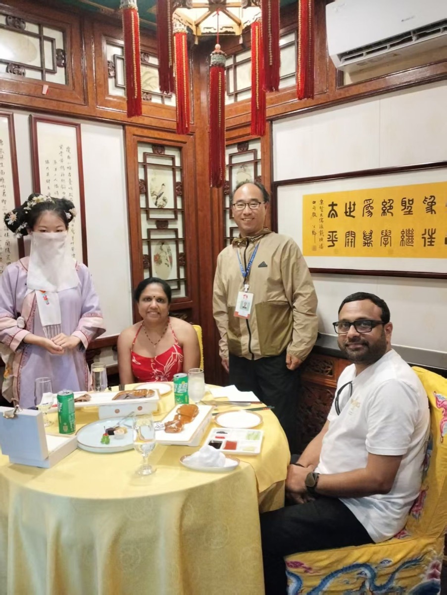 Travelers at a Peking duck dinner in a traditional Beijing restaurant