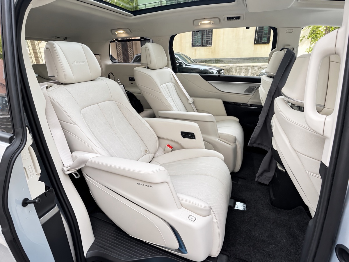 Reclining white leather captain's seats inside the private van